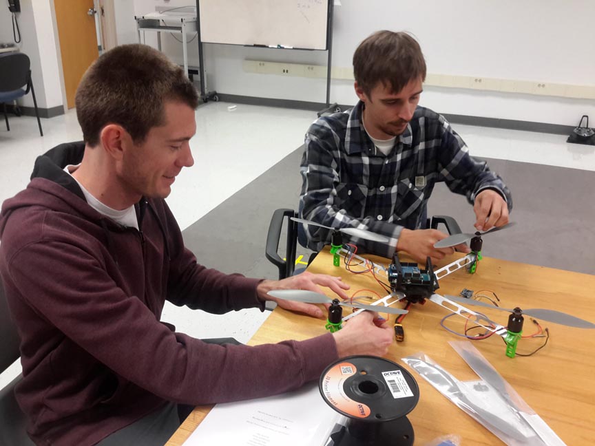 UT-Corpus Christi students Ian Gates (left) and Christoph Hintz review the characteristics of the 3-dimensional computer-aided design prototype. The experimental prototype should look and work like the 3D model.