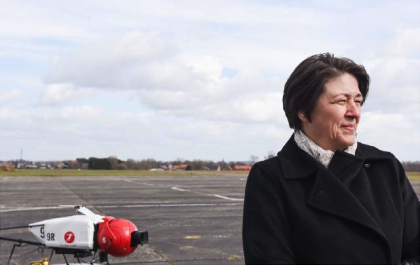 Violeta Bulc with a drone helicopter in the background. 